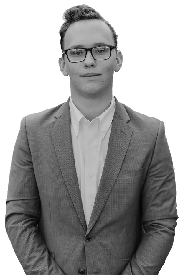 A black and white picture of Tucker Marcum in a suit